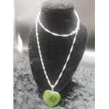 Silver necklace set with green stone heart pendant.