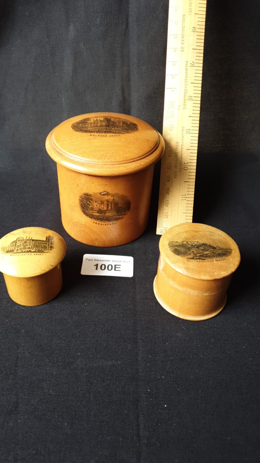 3 Mauchline ware jars and covers .