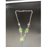 Heavy silver ornate themed necklace set with green and mother of pearl design.