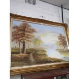 Large oil painting of countryside river scene signed Raymond in large gilt frame.