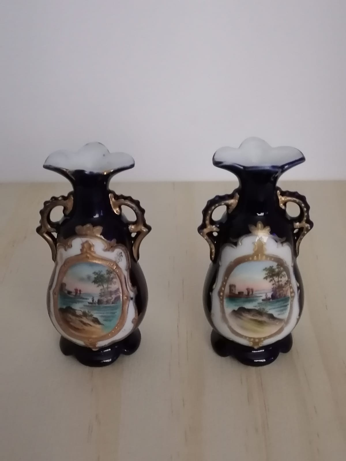 Pair of limoge style blue back ground vases depicting French style scene.