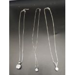 3 silver necklaces with pendants.