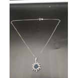 Silver necklace with stunning blue and clear stone pendant.