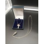 Silver chain with cross together with silver chain with shell pendant.