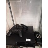 Playstation 3 slim line console with controller and power supply.