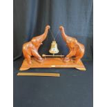 Large Carved Wood And Brass Dinner Gong In Shape Of 2 Elephants Holding Brass Bell 22 Inches Length