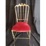 Early lady's budoir brass and red velvet chair.