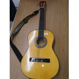Acoustic guitar with strap.