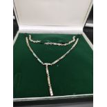 Silver necklace set with art deco mother of pearl design.