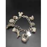 Heavy silver charm bracelet with charms.