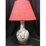 Early Chinese table lamp depicting blueish back ground and dragon pattern signed to the base.