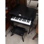 Kids small grand piano with stool.