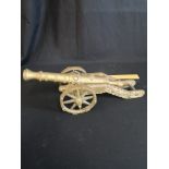 Heavy brass cannon model.