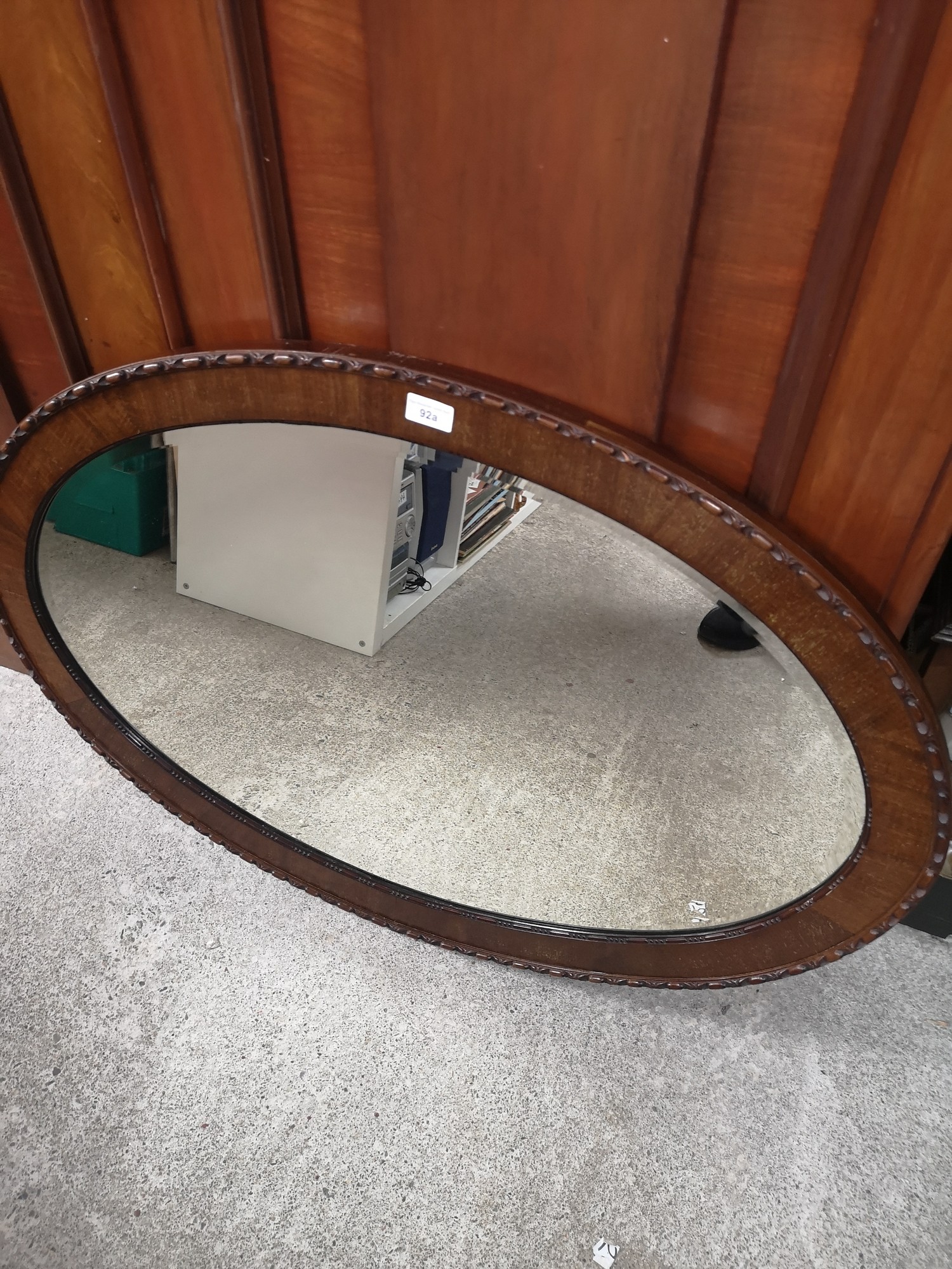 Reproduction carved oval mirror.