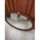 Reproduction carved oval mirror.