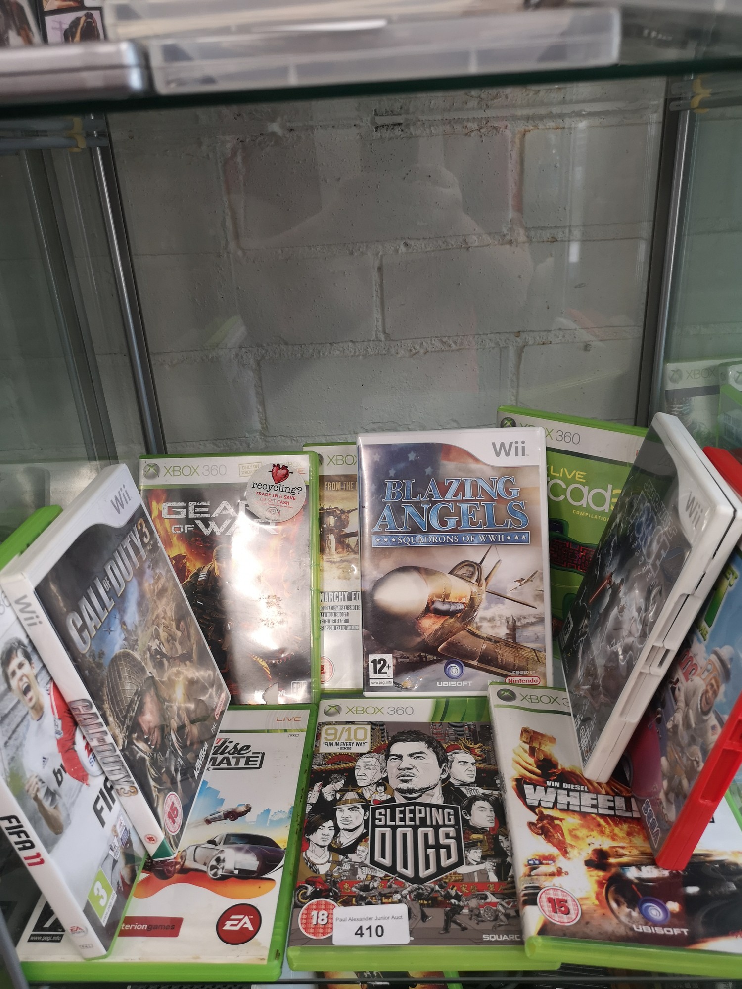 Shelf of xbox 360 & ninetendo wii games.