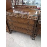 1900s oak chest of drawers in ornate design.