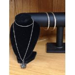 2 silver diamond cut bangles together with silver necklace set with ball chain with black stones.