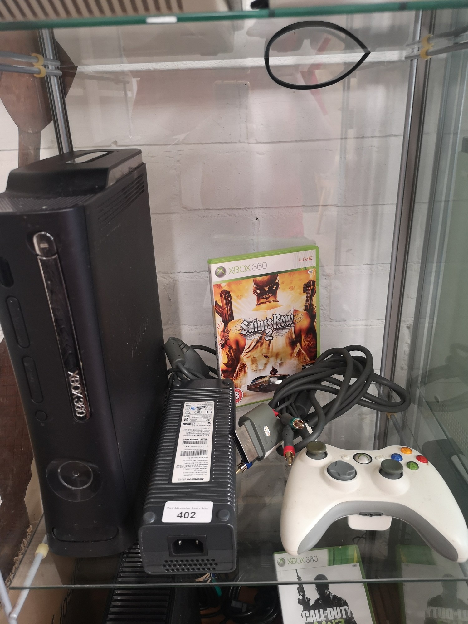 Xbox 360 console with controller and game.