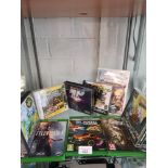 Shelf of xbox one games, playstation 1 games etc.