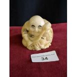 Oriental monk Netsuke signed to base.