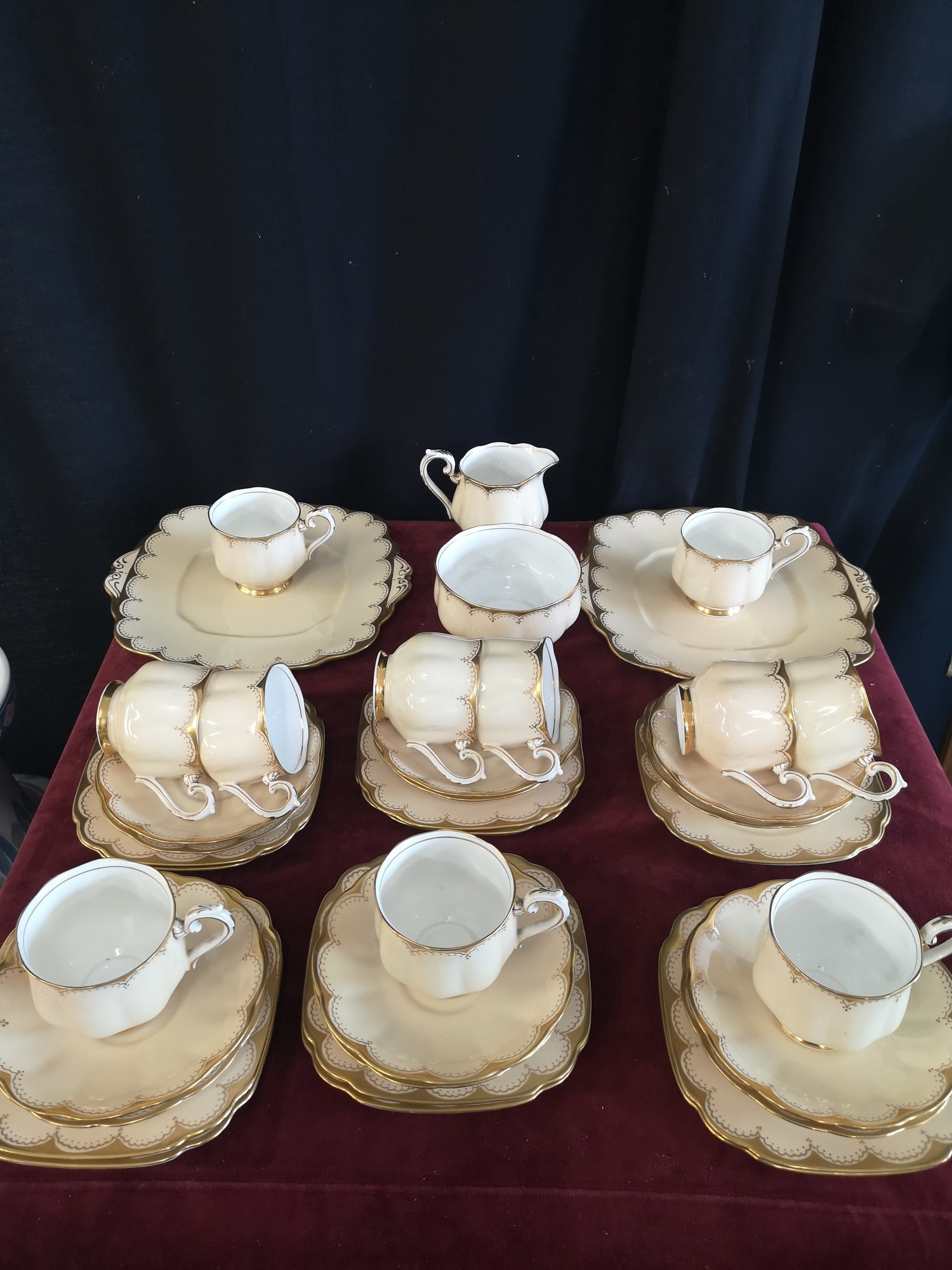 Large 1900s Royal Albert gilt tea set, set in cream back ground.