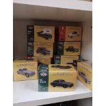 Shelf of vintage classic sport car models boxed.