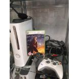 Shelf of xbox console with power supply and 360 game.