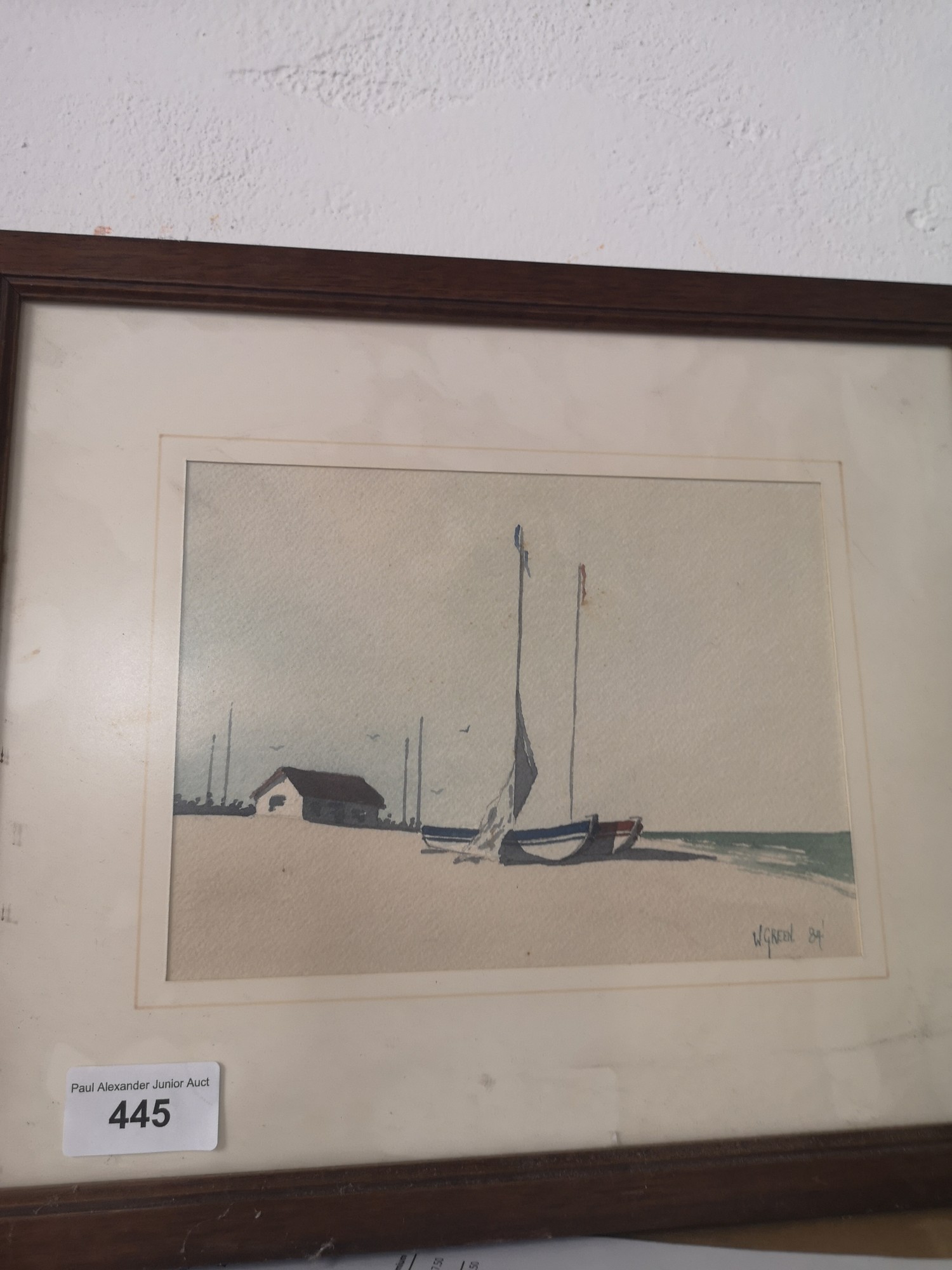 Water colour depicting boat scene on beach signed V Green.