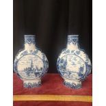 Pair of 1900s delft blue and white Dutch moon flask bottle necked vases. Stands 8.5 inches in