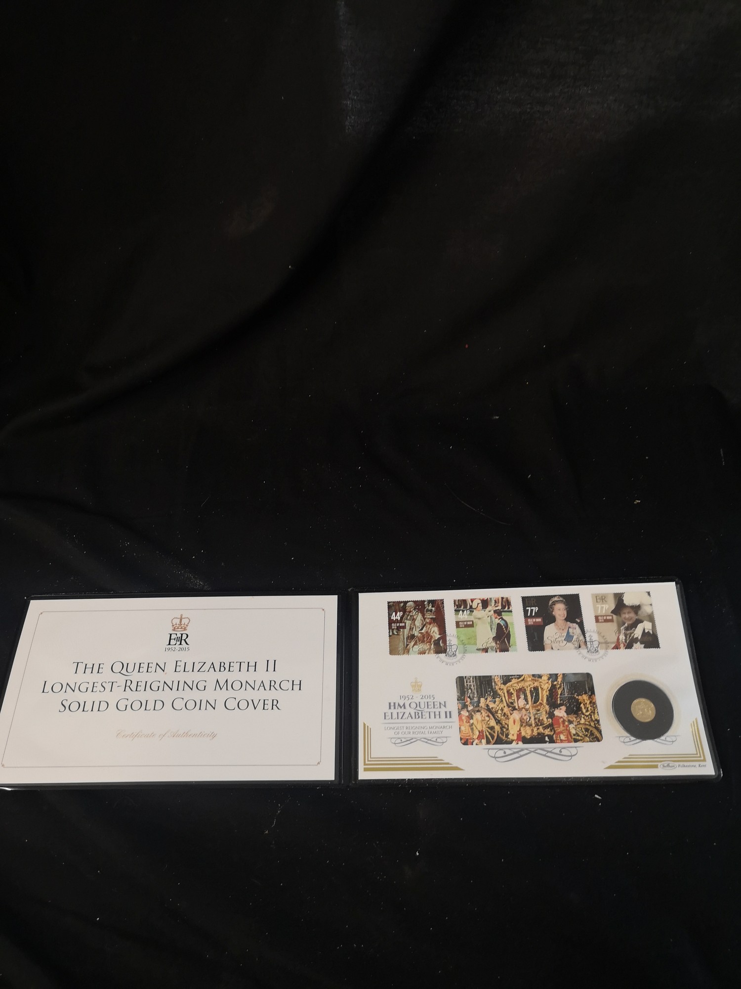 The Queen Elizabeth II longest reigning monarch solid gold coin 1st day cover.