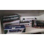 Shelf of boxed Eddie Stobart models etc.