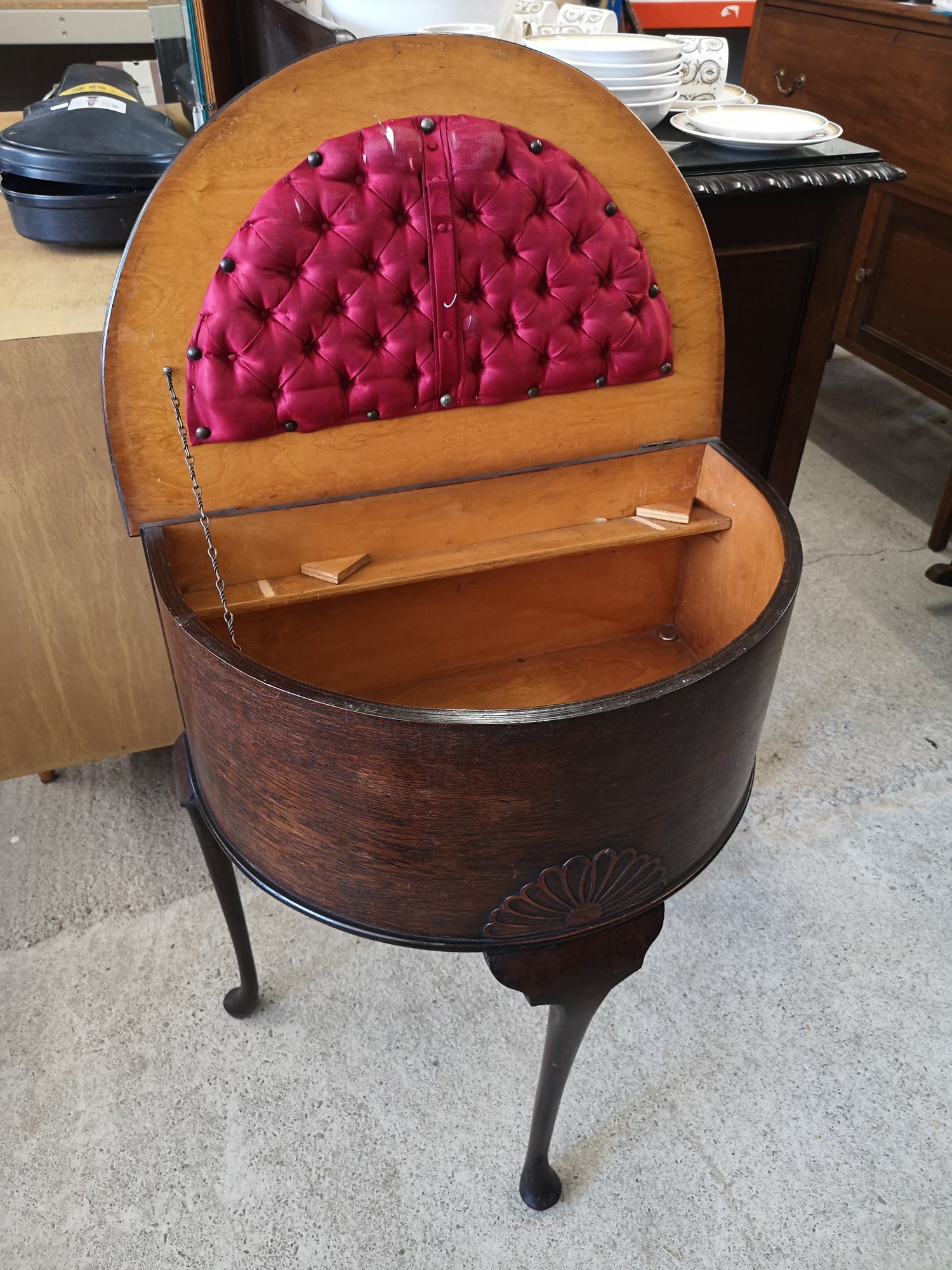 Ornate half moon sewing box with fitted interior.