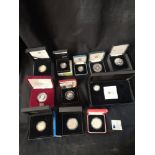 Collection of boxed proof coins.
