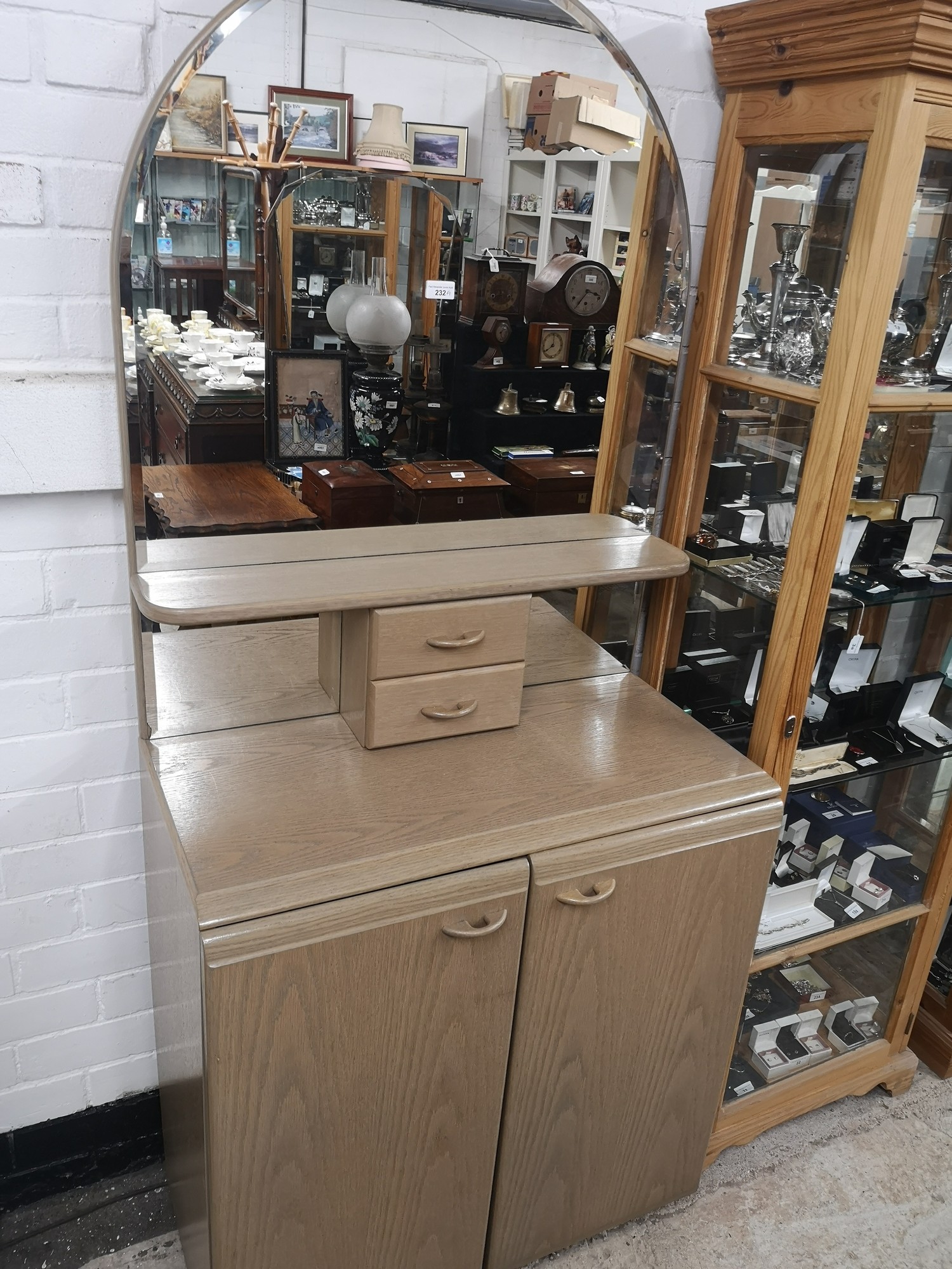 Art deco mirrored back dresser with cabinet base.