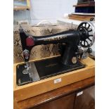 Singer sewing machine with pedal in fitted casing.