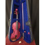 Harlequin pink Violin with bow in fitted case.