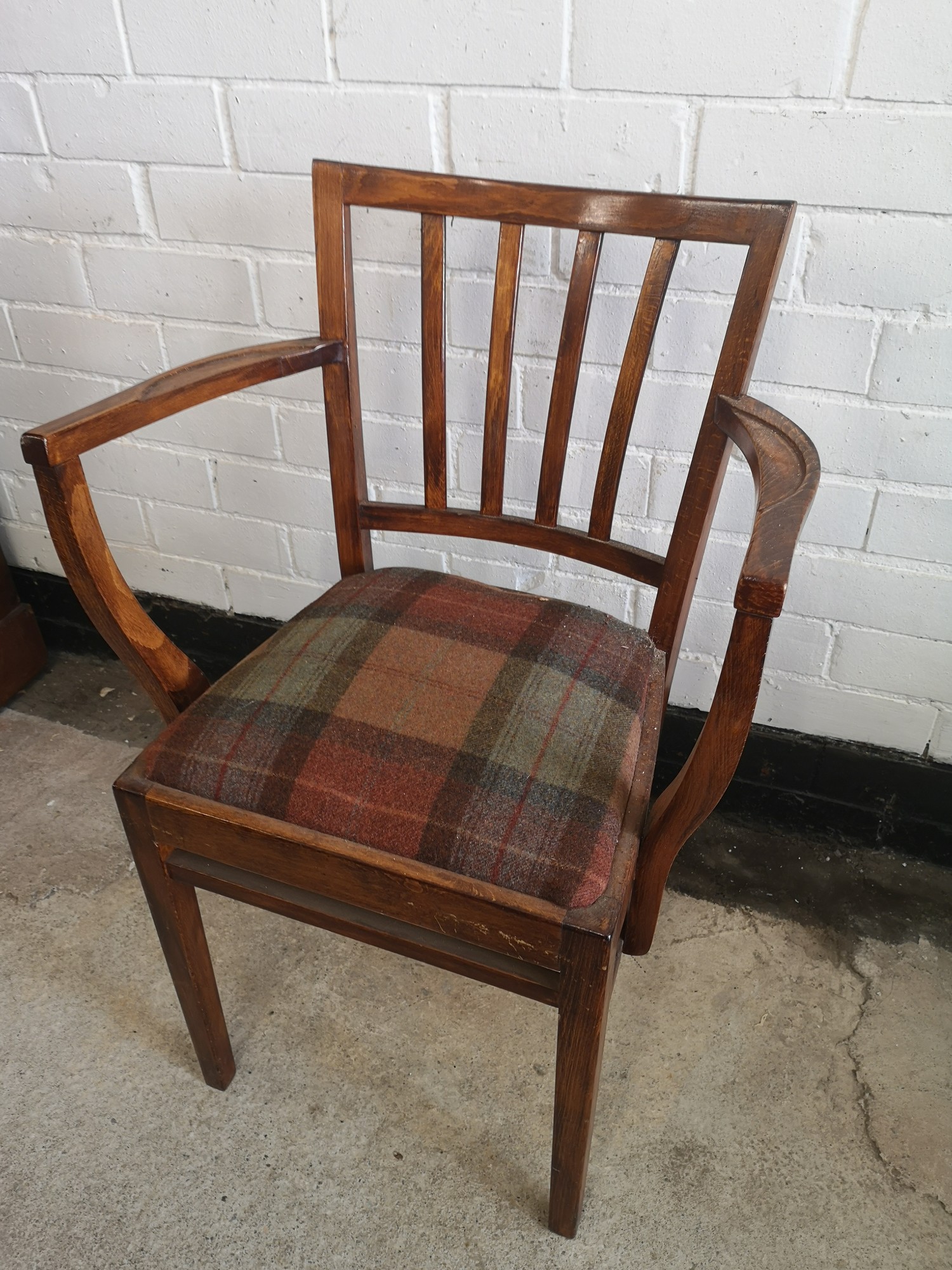 Arts and crafts arm chair with tartan upholstery.