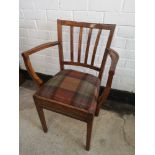 Arts and crafts arm chair with tartan upholstery.