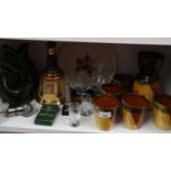 Shelf of collectables includes whisky jug and glass set on wooden plinth, gurgling jug etc.