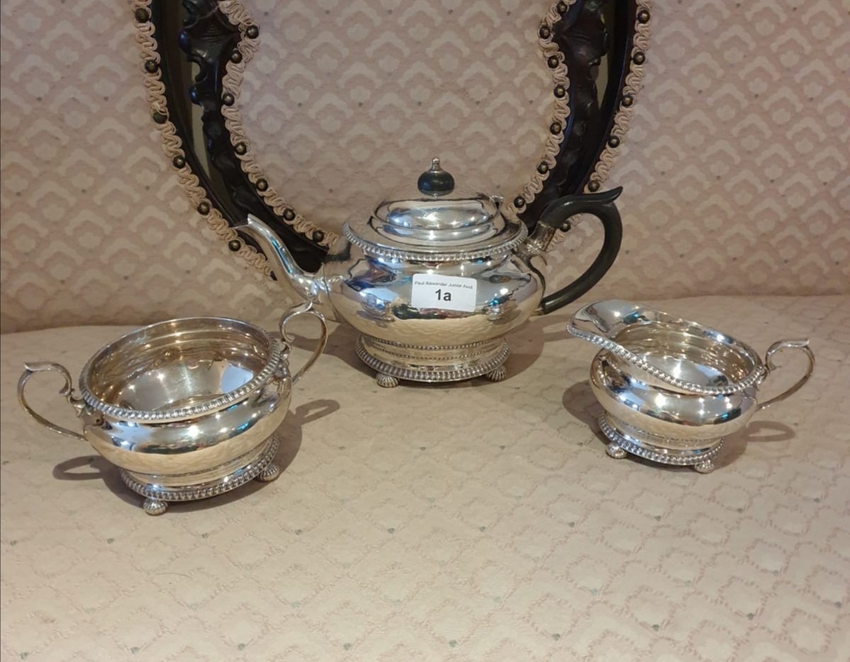 3 piece silver Hall marked tea service on pad feet serrated edges to top and bottom. 900 grams.