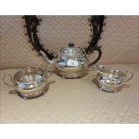 3 piece silver Hall marked tea service on pad feet serrated edges to top and bottom. 900 grams.