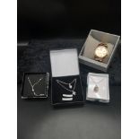 Silver necklaces with pendants together with Guess watch.