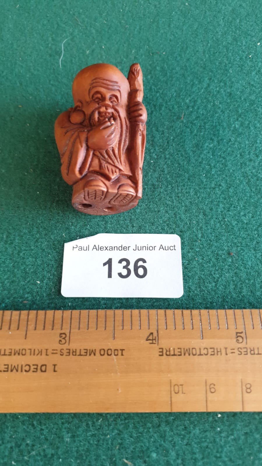 Carved fruit wood netsuke of Oriental monk with signature to base.