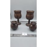 Pair of Antique wooden goblets depicting Rhino Foliage together with matching cruets.