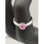 9ct white gold pink stone ring set with clear stone shoulders.