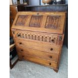 1900s Oak linen fold church style bureau with fitted interior.