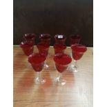 Collection of art glass red sherry glasses.