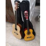 2 Acoustic guitars with bags .