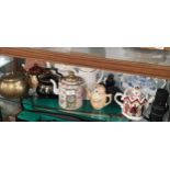 Shelf of Tea pots etc .